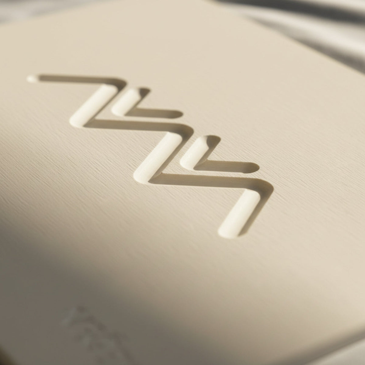 Macro of the debossed Ridgeline zigzag motif on the natural bone white MEGEM Alpine diatomaceous earth stone bath mat