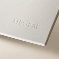 Close view of the debossed MEGEM wordmark and thick edge on the Alpine mat's chalk white surface