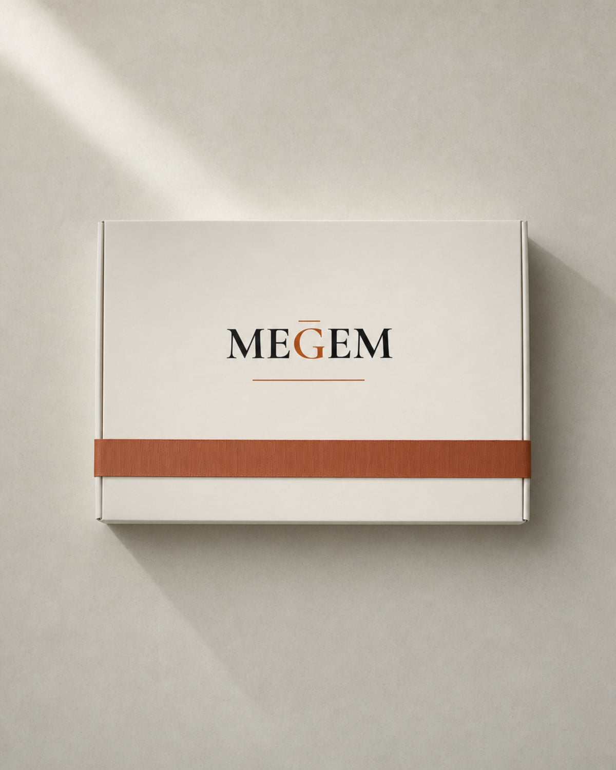 MEGEM gift box tied with a single copper ribbon