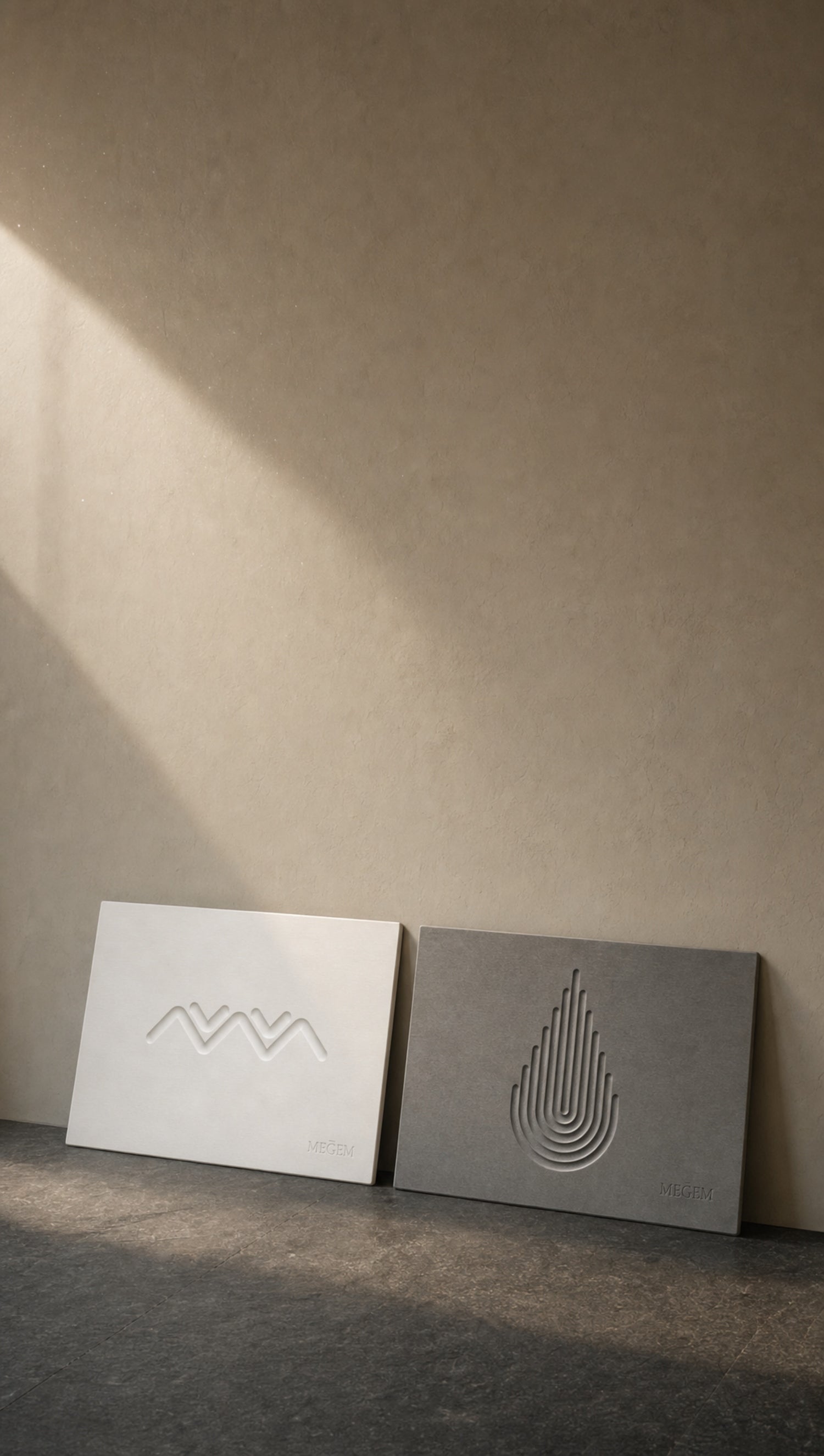 MEGEM Alpine and Summit diatomaceous earth stone bath mats leaning against a warm plaster wall in afternoon light